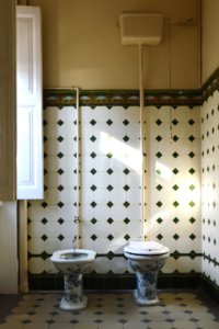 A beautiful paired porcelain bidet and toilet in a vintage bathroom