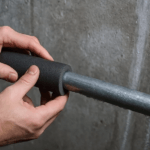 Fall Plumbing Prep in Chicago: Prevent Freeze Damage Before Temperatures Drop Plumbing technician installing pipe insulation on a metal pipe
