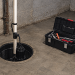 Sump Pump Maintenance Before Winter: Testing, Pit Cleaning, and Warning Signs Sump pump installed in basement with open toolbox